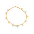 A delicate gold anklet features hanging openwork flower charms arranged in a circle against a white background.