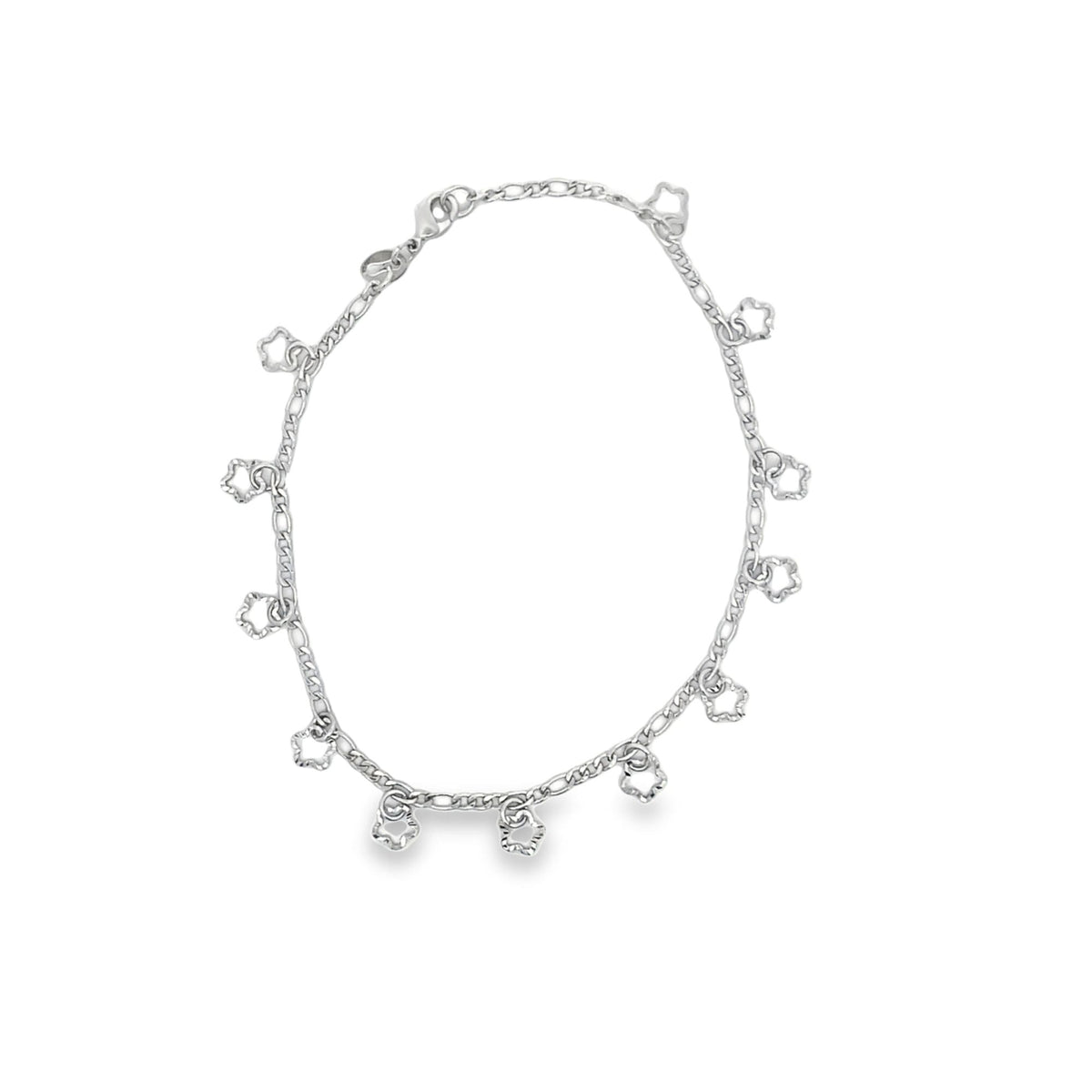 A delicate silver anklet adorned with dangling flower charms lies in a circle against a clean white background.