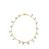 A delicate gold chain necklace dangles charming blue evil eye charms against a clean white background.