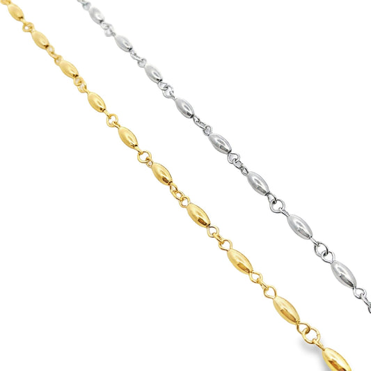 Two delicate necklaces display alternating gold and silver rice-bead links diagonally across a clean white background.