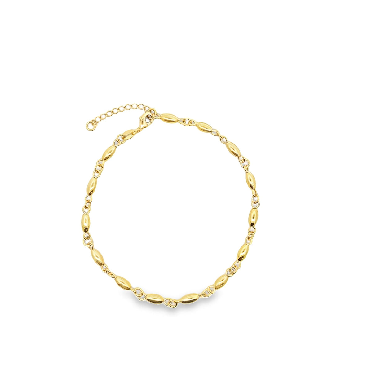 A delicate gold chain bracelet features polished oval beads linked together on a white background.