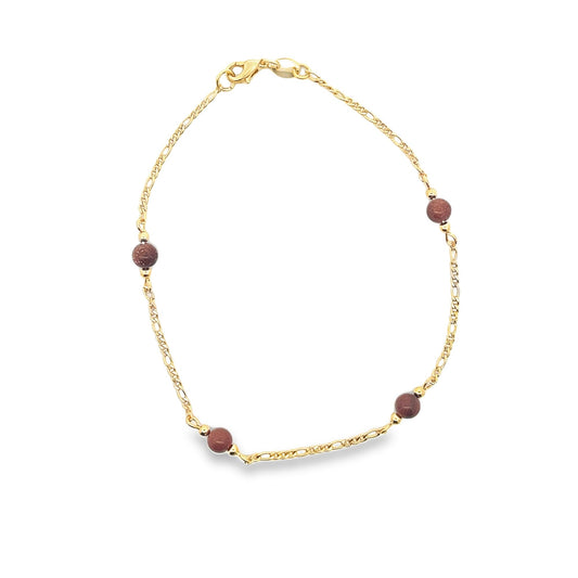 A delicate gold chain bracelet features four round brown gemstone beads spaced evenly along its length.