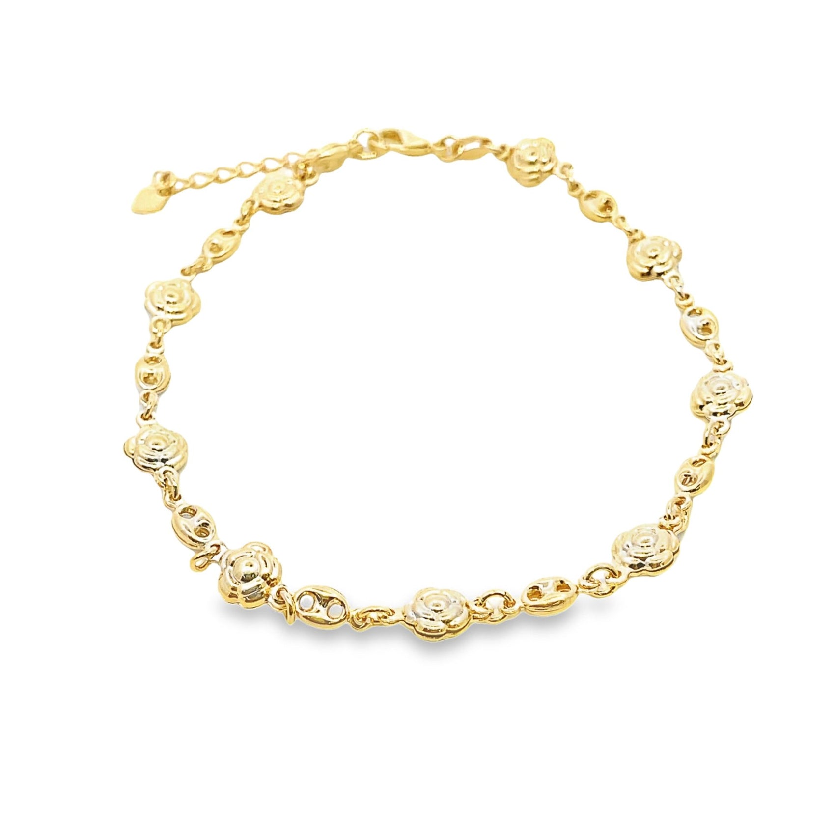 A delicate gold chain bracelet features alternating flower charms and textured links against a white background.