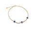 A gold tennis anklet encrusted with sparkling rhinestones features three blue evil eye charms displayed against a plain white background.