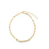 A delicate gold chain necklace displays intricately textured oval links arranged in a circular design against a plain white background.