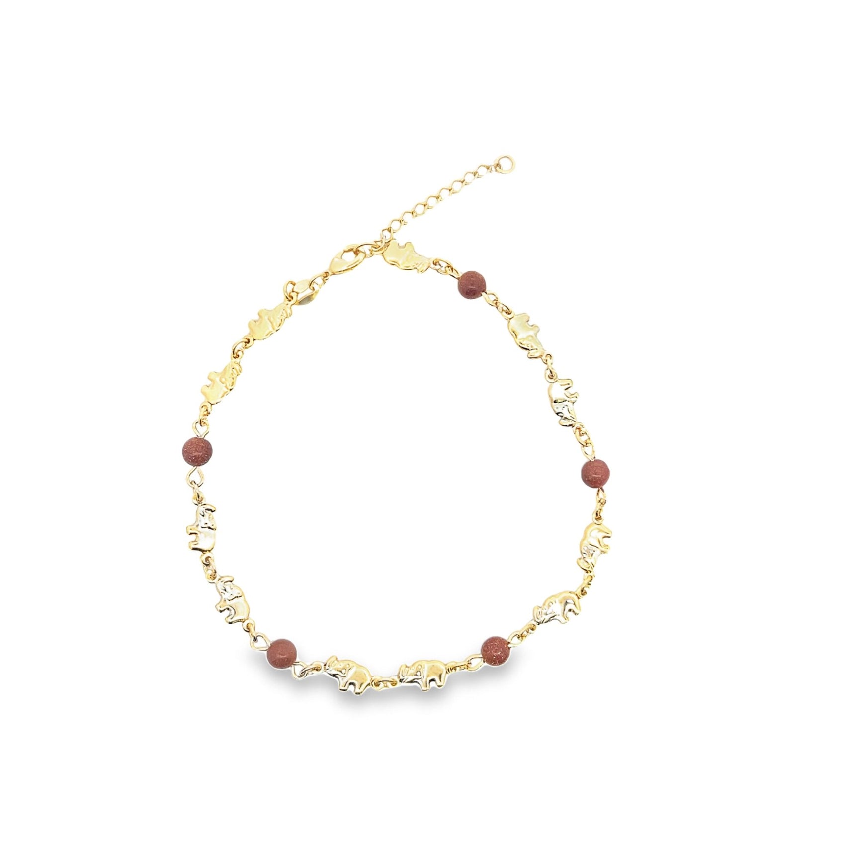 A gold chain necklace features alternating elephant charms and reddish-brown gemstone beads.