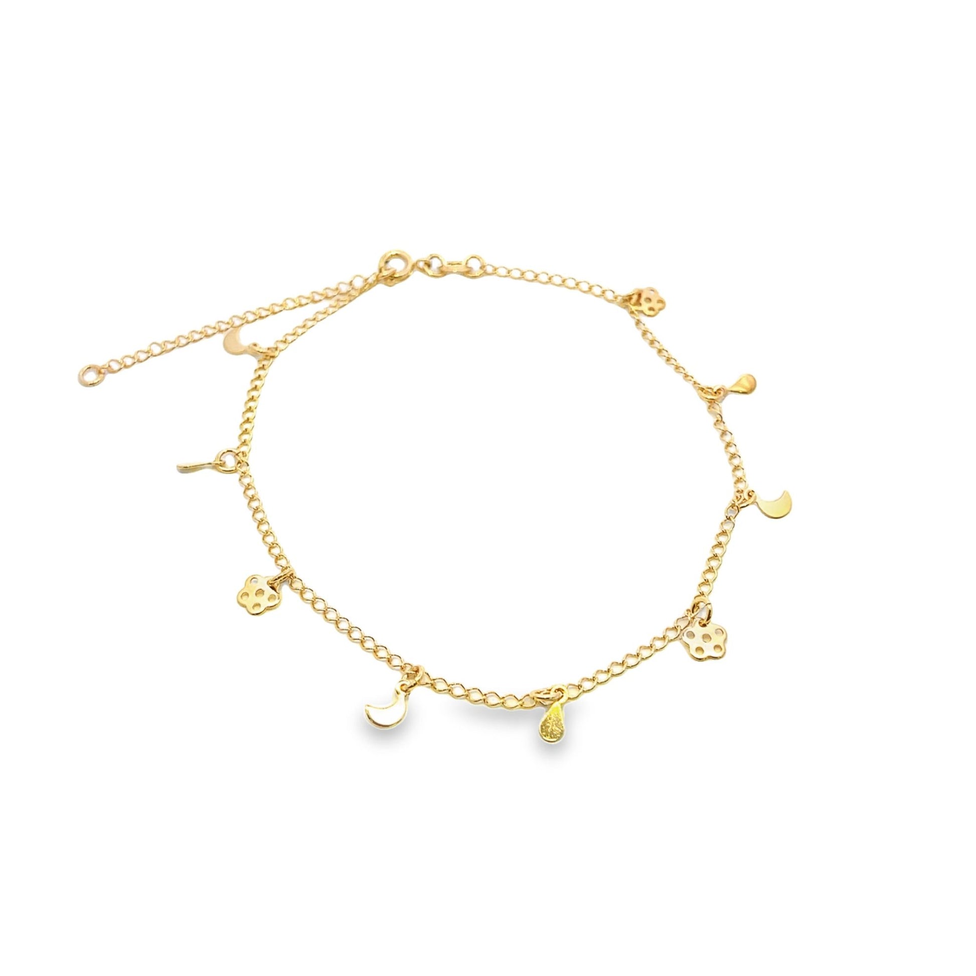 A delicate gold charm anklet displays dangling charms including crescent moons, flowers, and teardrops against a plain white background.