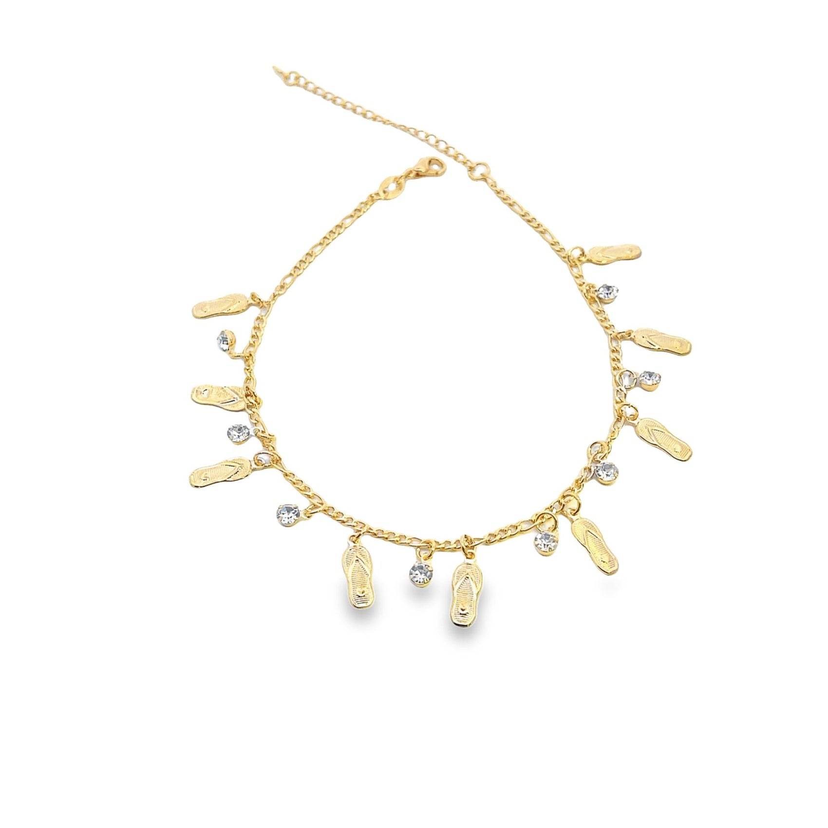 A gold anklet features dangling charms shaped like flip-flops and sparkling rhinestones against a white background.