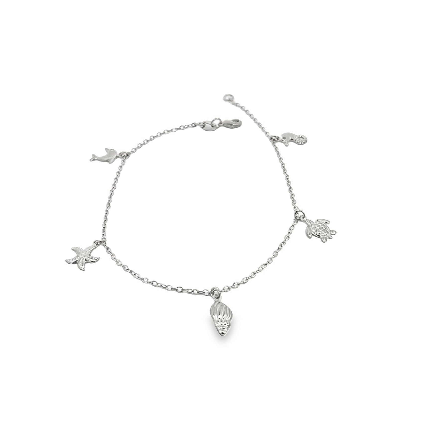 A silver charm bracelet features dangling oceanic charms including a starfish, seashell, turtle, dolphin, and seahorse against a plain white background.