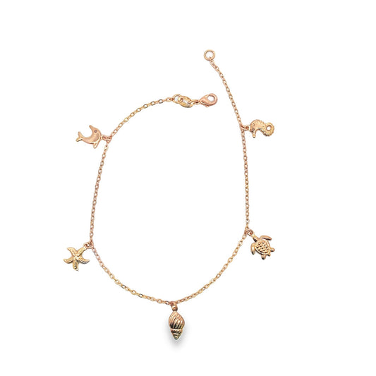 A delicate rose gold charm bracelet dangles with ocean-themed pendants including a starfish, seahorse, turtle, and seashell against a plain white background.