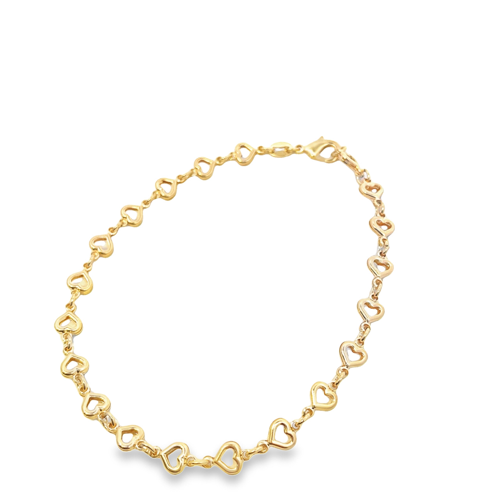 A delicate gold heart-link bracelet curves gracefully against a clean white background.