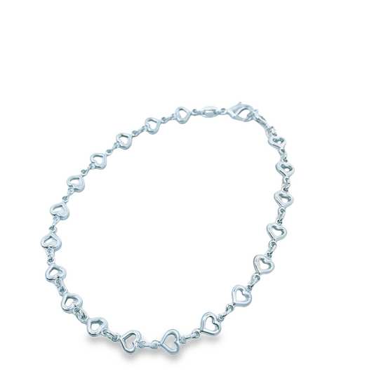A delicate sterling silver heart-link bracelet rests against a clean white background.