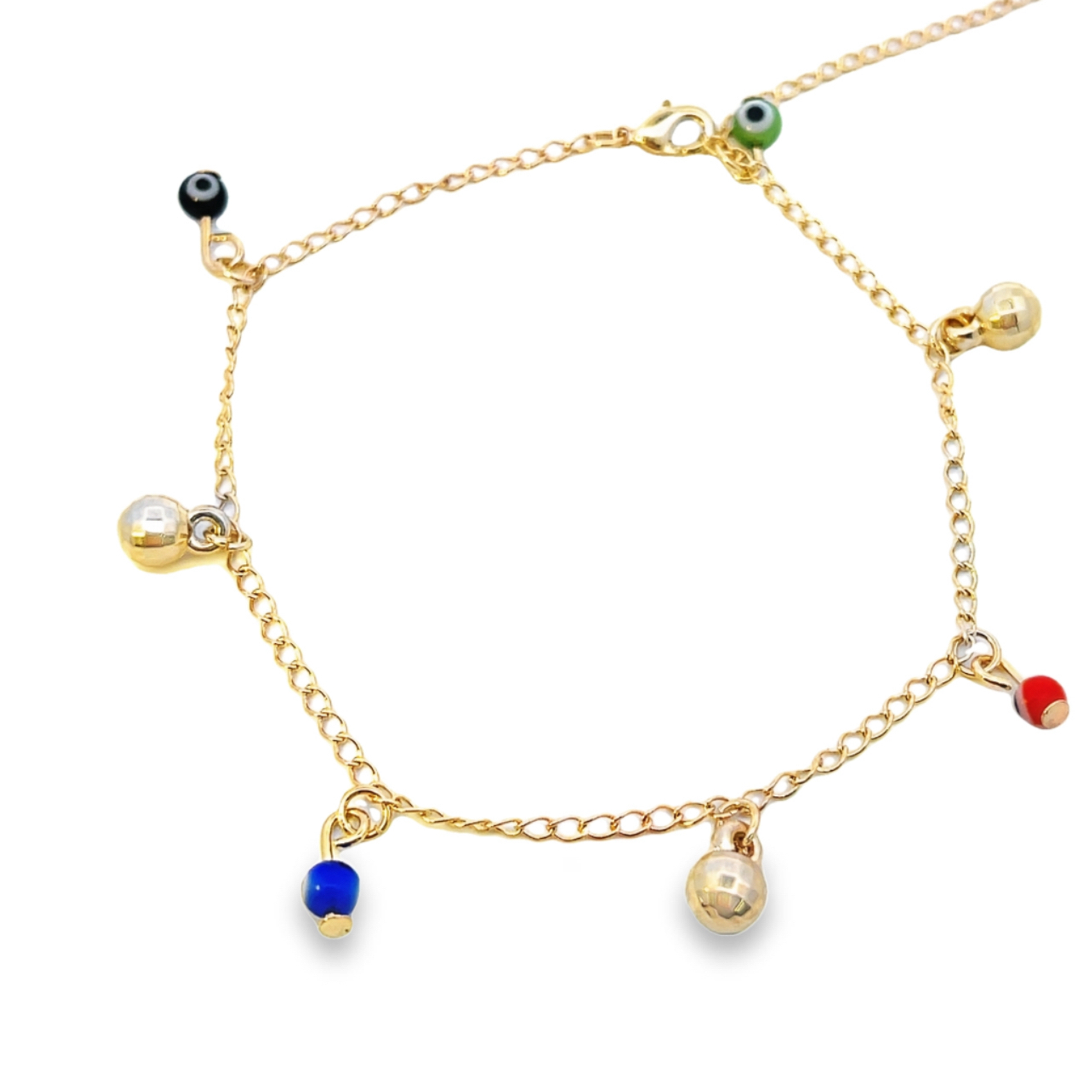 A delicate gold anklet features colorful evil eye beads and dangling metallic charms against a clean white background.