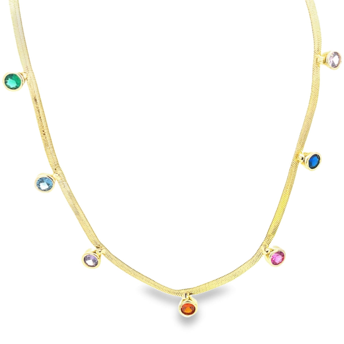 A gold herringbone chain necklace sparkles with colorful gemstone charms dangling along its length against a white background.