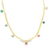 A gold herringbone chain necklace sparkles with colorful gemstone charms dangling along its length against a white background.