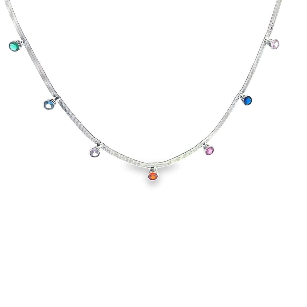 A delicate silver herringbone chain necklace features dangling multi-colored gemstone charms spaced evenly along its length.