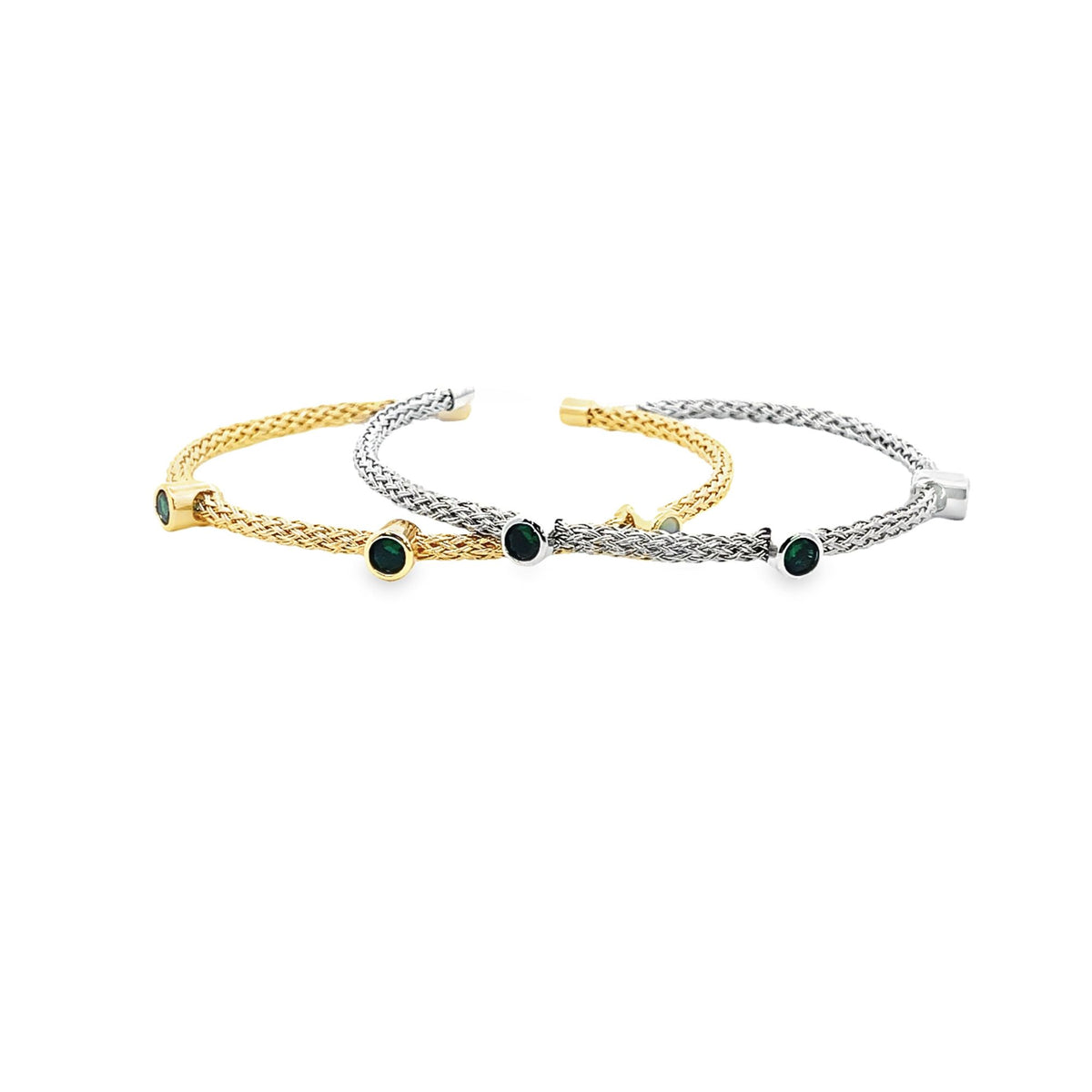 Two woven metallic cuff bracelets feature dark green gemstone accents against a plain white background.