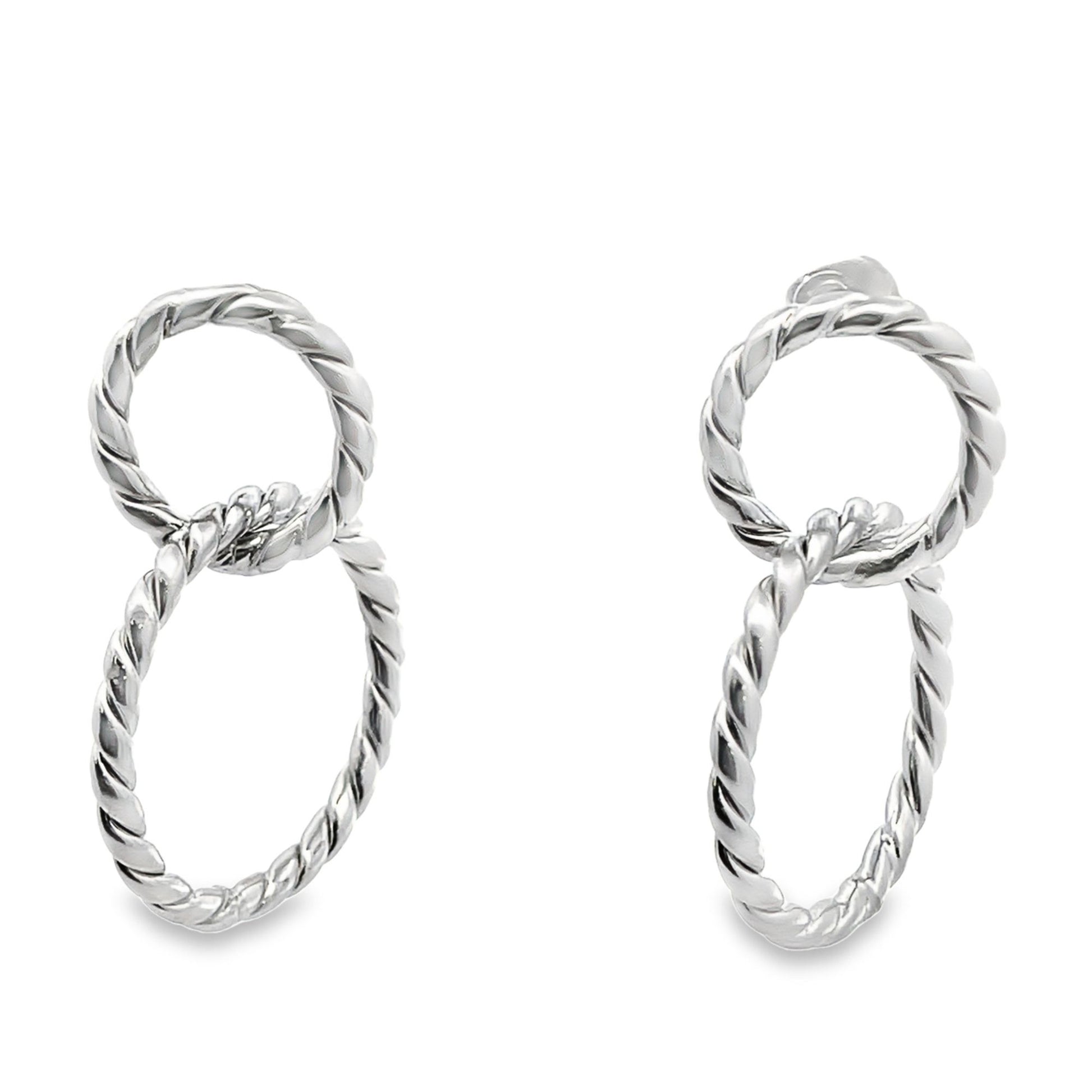 A pair of shiny silver twisted rope hoop earrings display an interlocking figure-eight design on a clean white background.