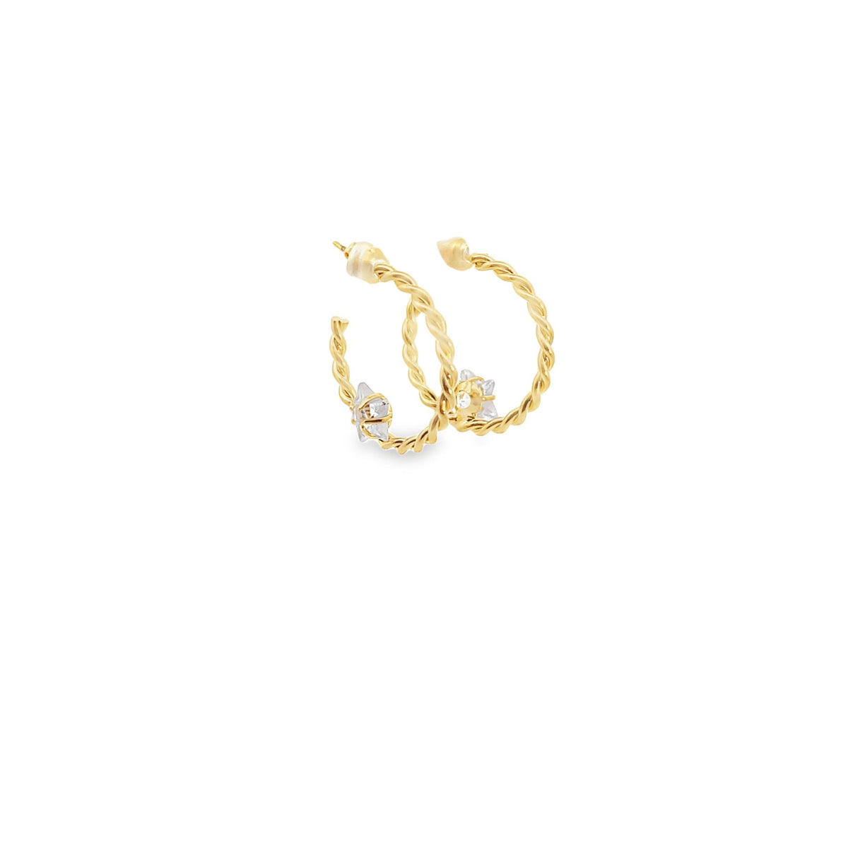A pair of twisted gold hoop earrings adorned with sparkling crystal accents rests against a clean white background.