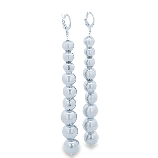 A pair of long, silver-toned drop earrings features a cascading chain of polished metal spheres in graduating sizes against a clean white background.