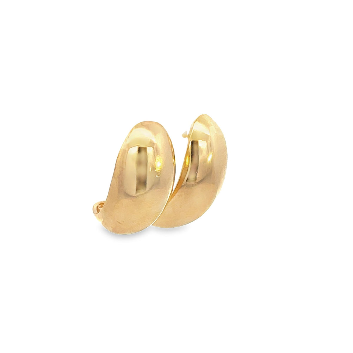 A pair of polished gold chunky huggie hoop earrings gleams against a white background.