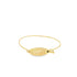 A delicate gold bangle bracelet features an oval plaque engraved with the word "LOVE" and a small black gemstone.