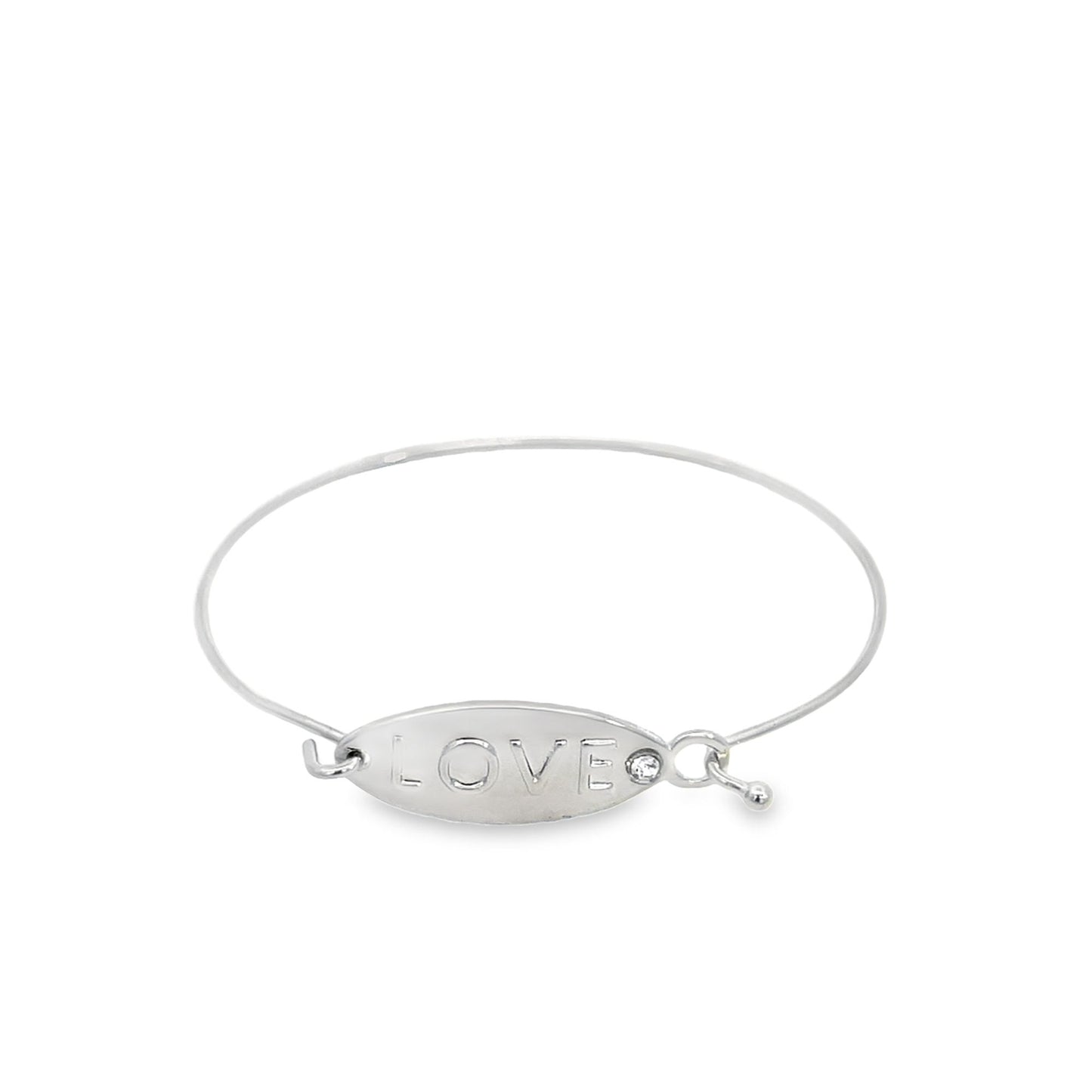 A silver bangle bracelet features an oval plate engraved with the word LOVE and a sparkling crystal accent.