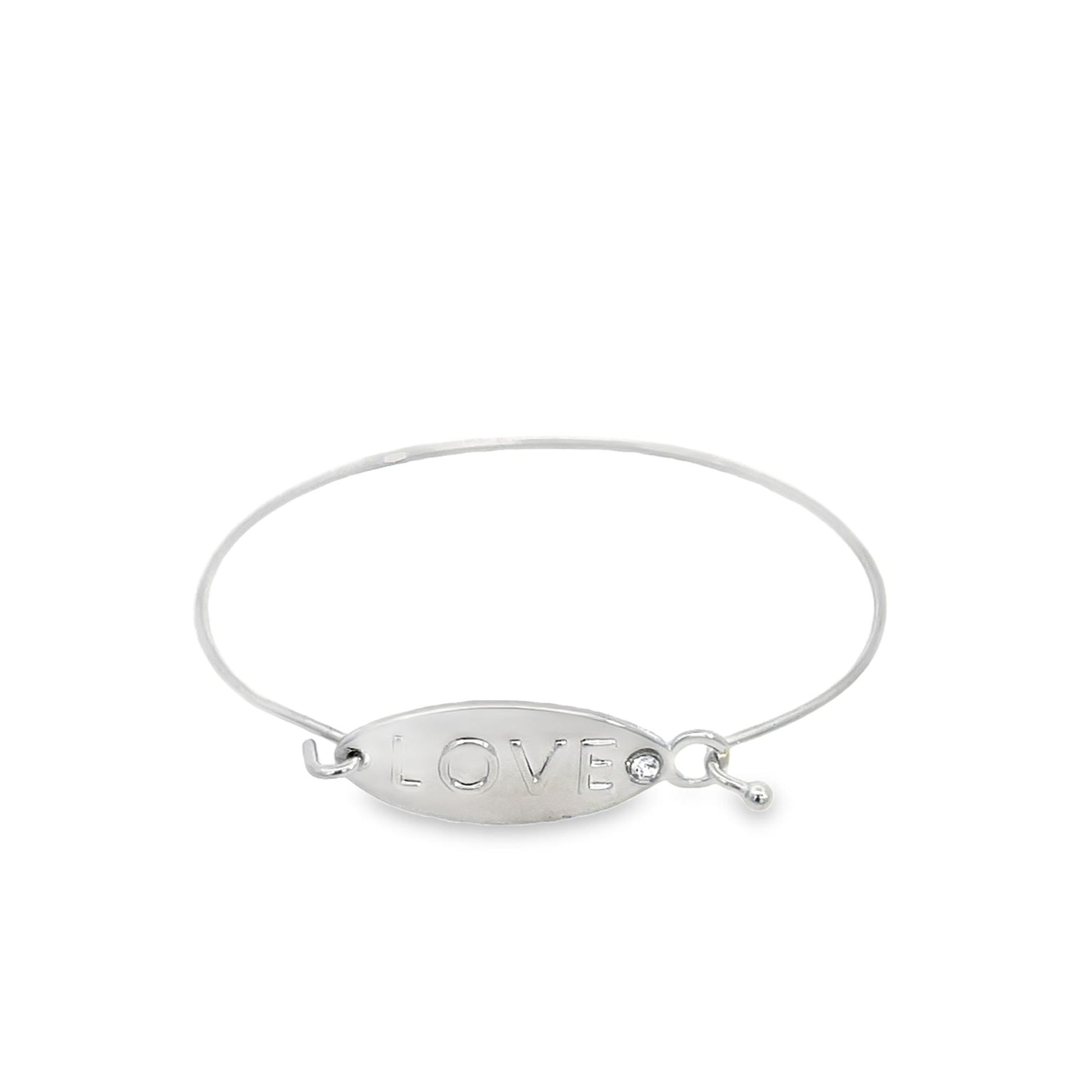 A silver bangle bracelet features an oval plate engraved with the word LOVE and a sparkling crystal accent.