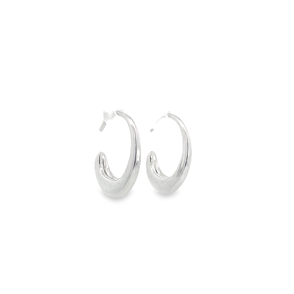 A pair of shiny silver hoop earrings rest on a clean white background.