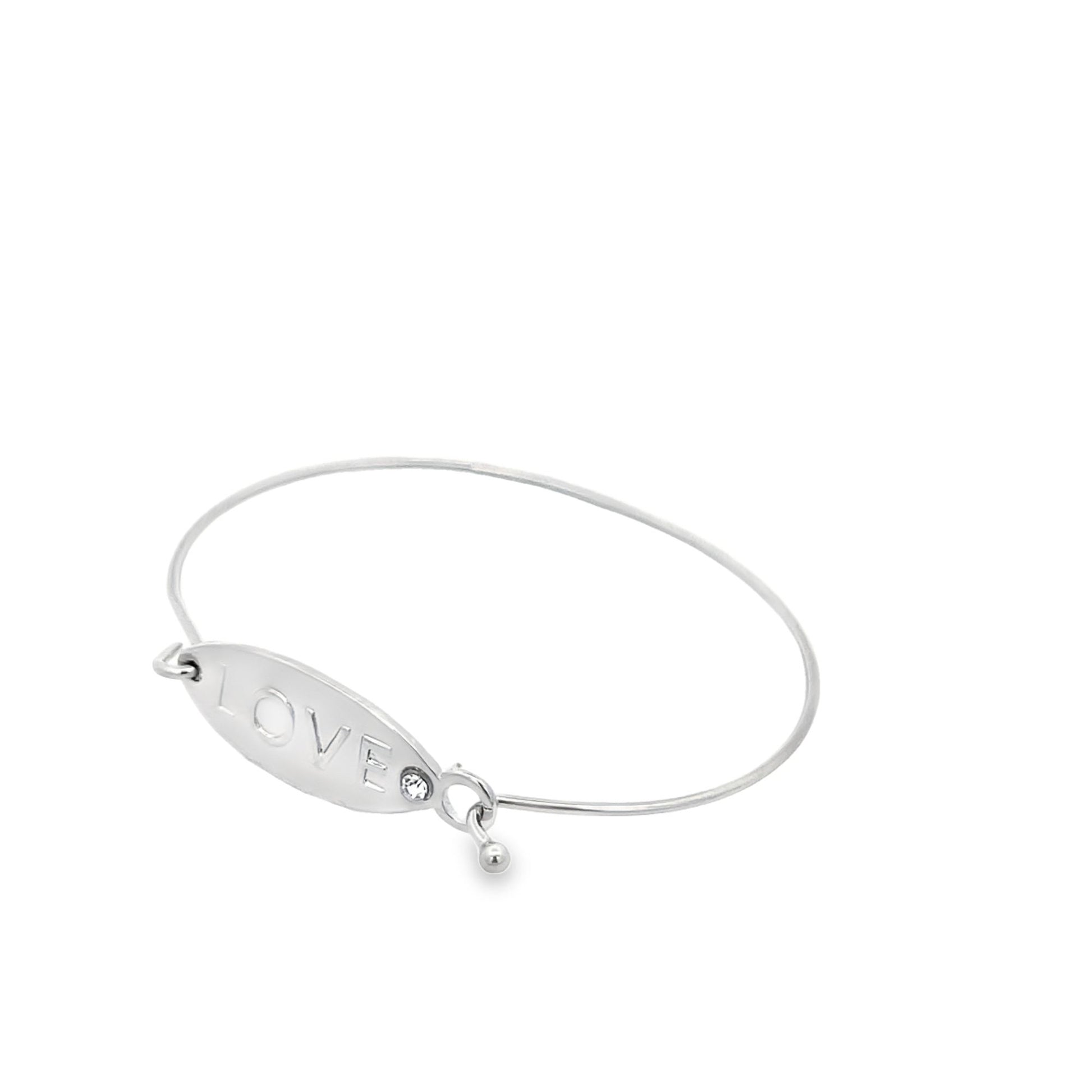 A silver wire bangle bracelet features an oval plate engraved with the word "LOVE" and a dangling charm.