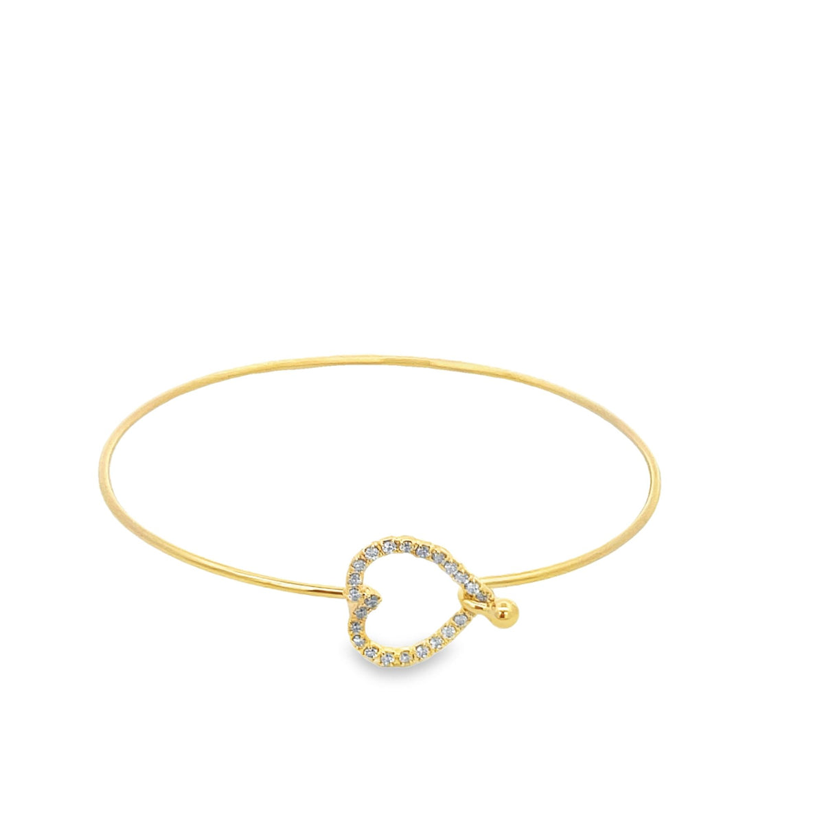A delicate gold bangle bracelet features a sparkling diamond-encrusted heart clasp against a clean white background.