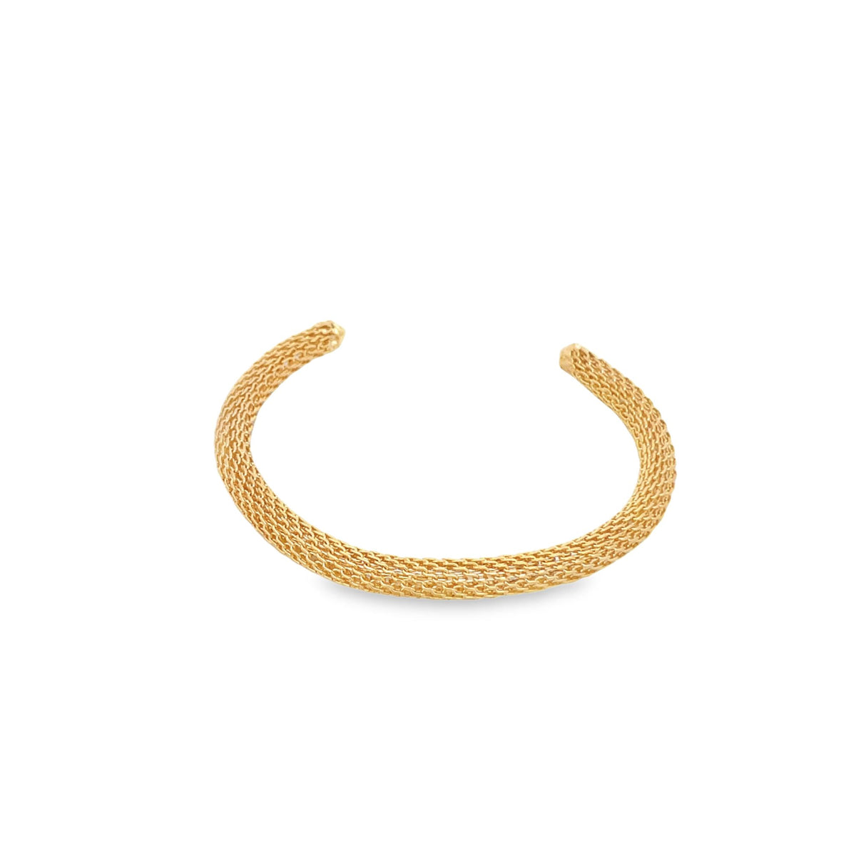 A textured gold mesh cuff bracelet rests on a clean white background.