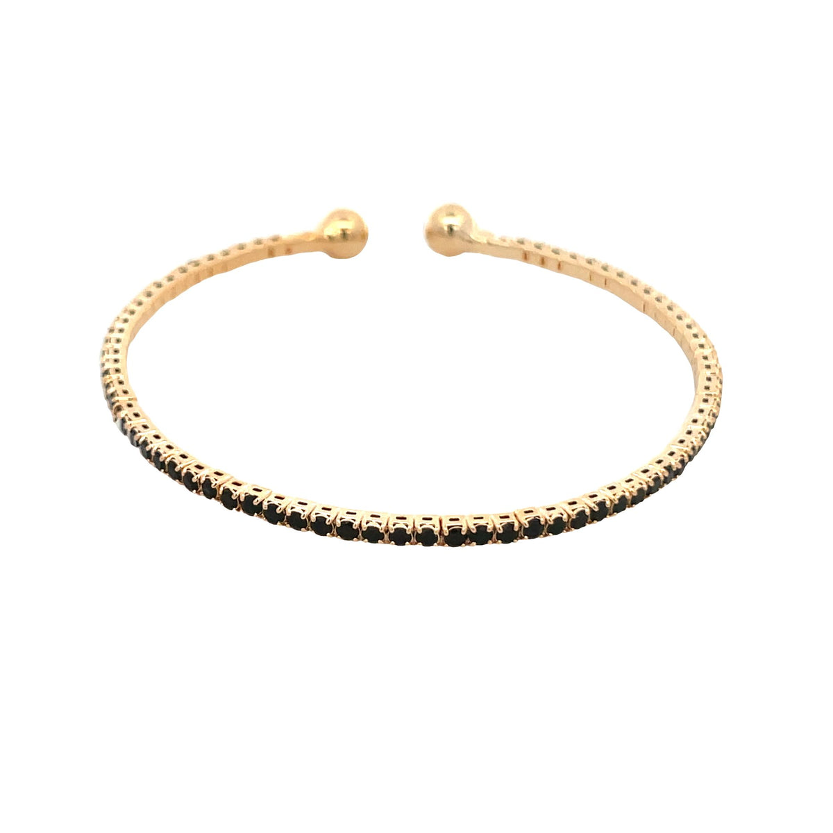 An open gold cuff bracelet features a delicate row of sparkling black stones and rounded ball ends.