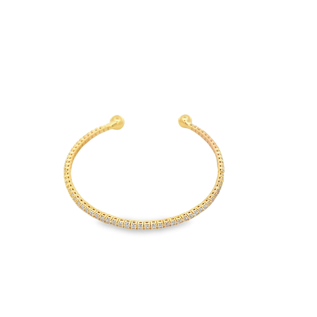 A delicate gold diamond cuff bracelet sparkles against a clean white background.