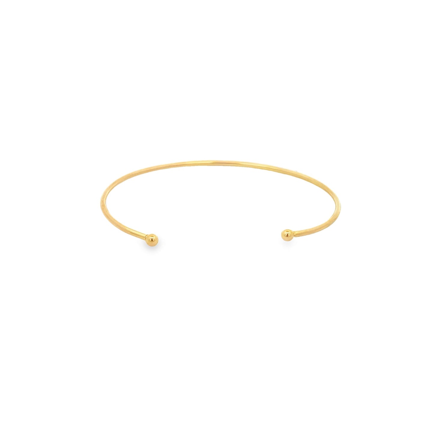 A minimalist gold cuff bracelet rests on a clean white background, showcasing its sleek open design with ball ends.