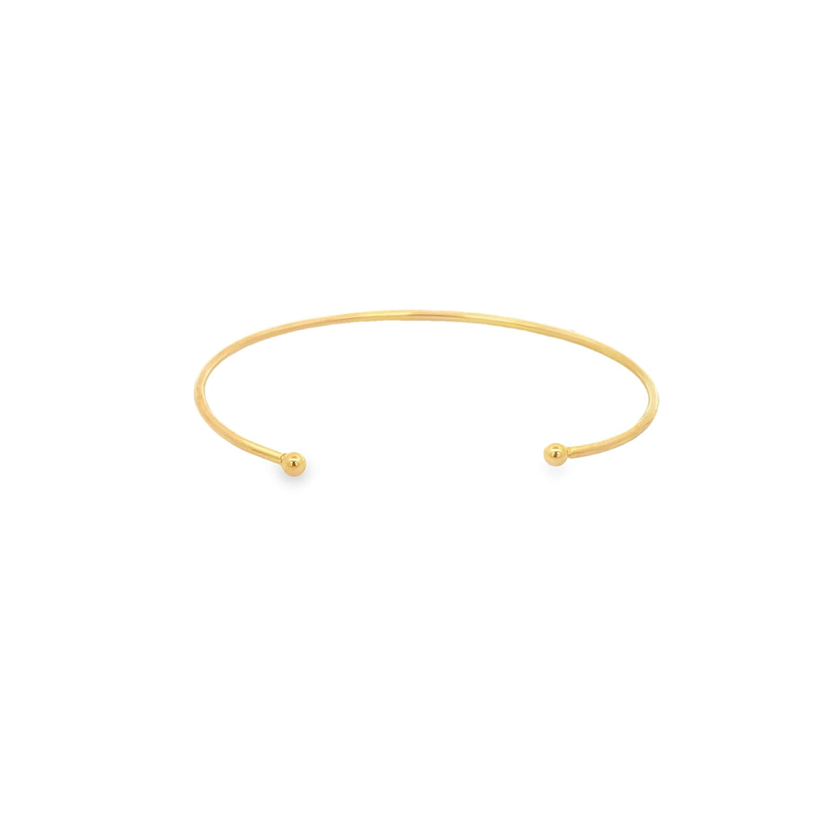 A minimalist gold cuff bracelet rests on a clean white background, showcasing its sleek open design with ball ends.
