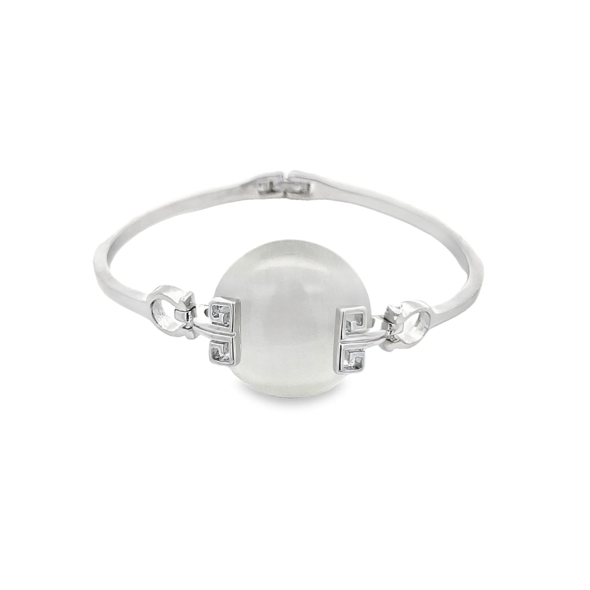 A silver hinged bangle bracelet features a large central white pearl flanked by ornate geometric clasps.