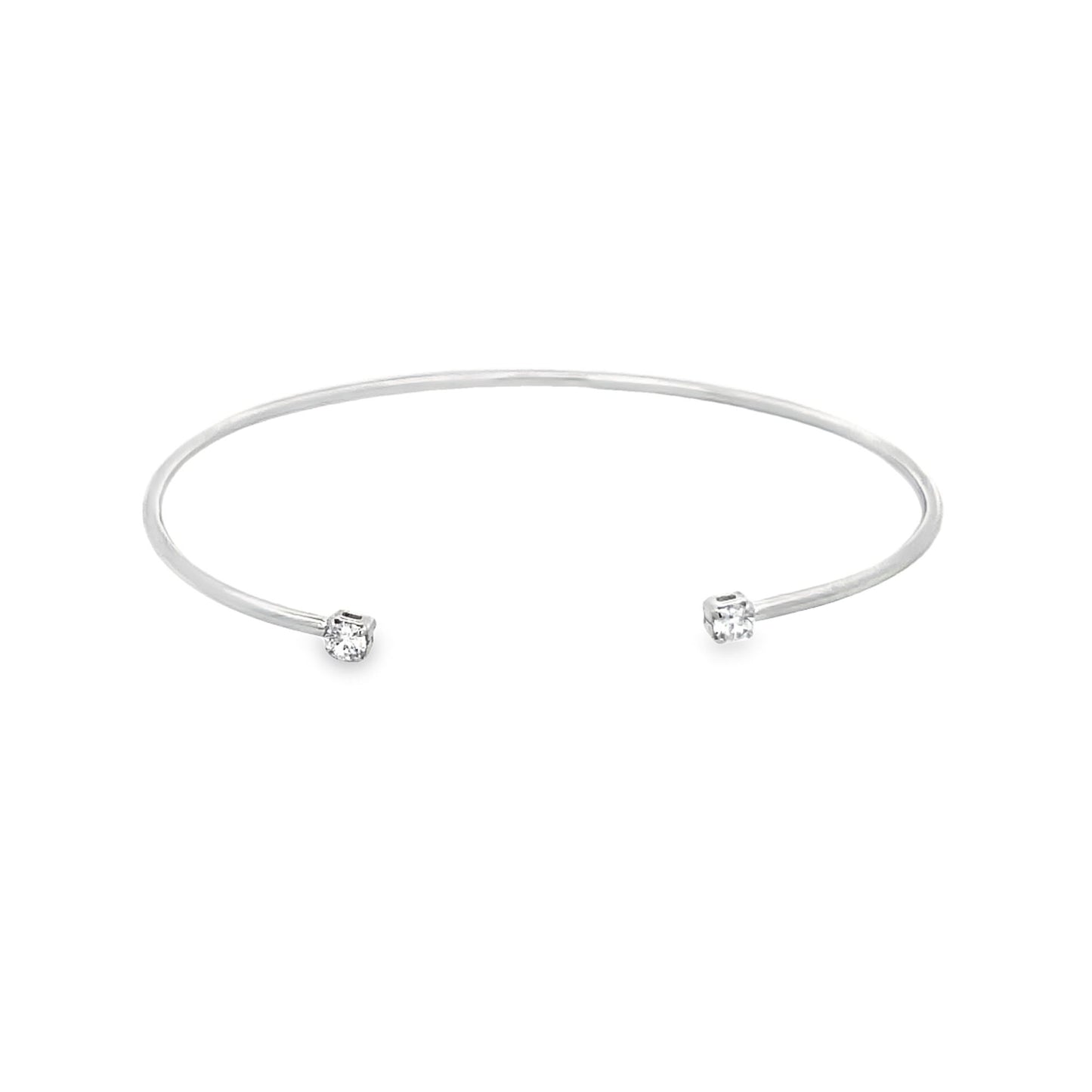 A sleek silver cuff bracelet features a sparkling diamond set at each open end against a clean white background.
