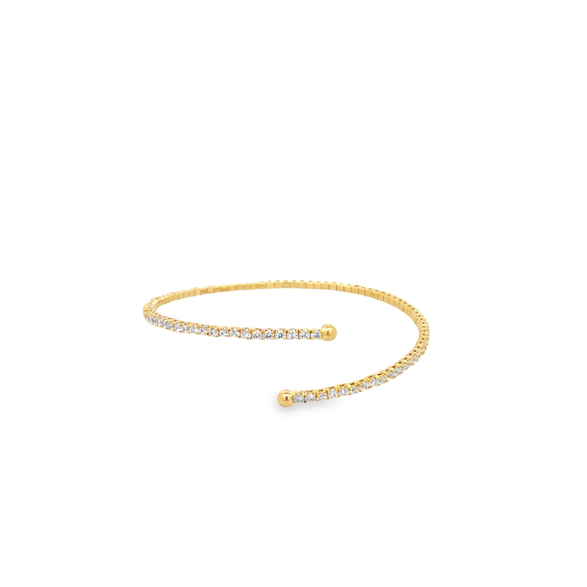 A delicate gold diamond tennis bracelet curves open against a clean white background.