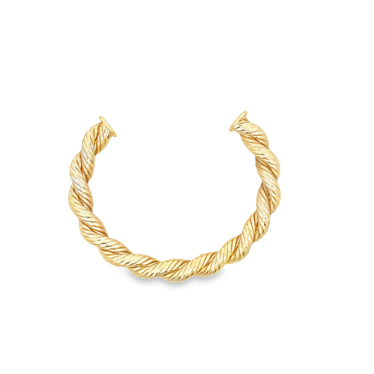 A gleaming gold twisted rope cuff bracelet rests against a clean white background.