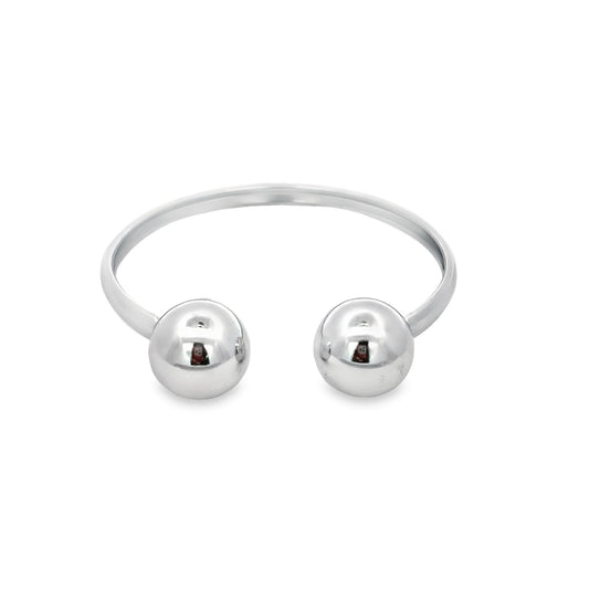 A polished silver bypass ring features two smooth, spherical ball ends against a clean white background.