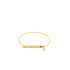 A sleek gold bangle bracelet features an engraved EKG heartbeat line and a sparkling red gemstone accent on its central metal bar.