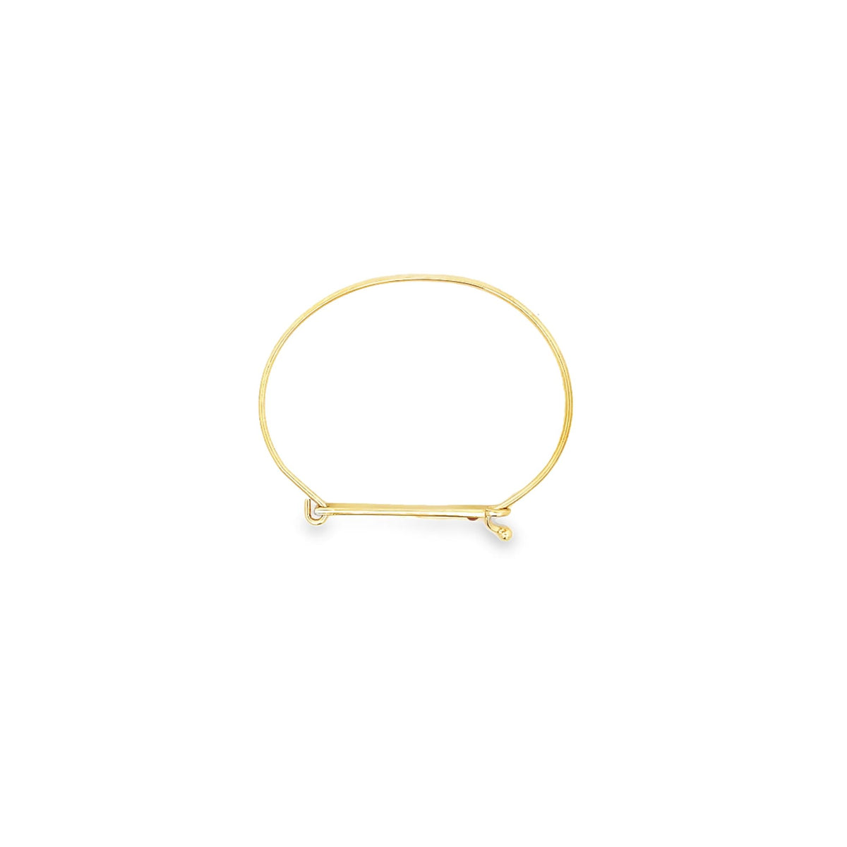 A minimalist gold wire bangle bracelet rests against a clean white background.