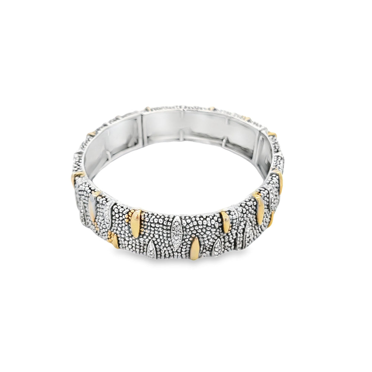 A textured silver and gold two-tone bangle bracelet rests against a clean white background.