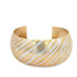 A wide tri-color gold cuff bracelet features diagonal stripes of yellow, white, and rose gold with textured detailing against a plain white background.