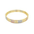 A shiny tri-color gold bangle bracelet gleams against a plain white background.
