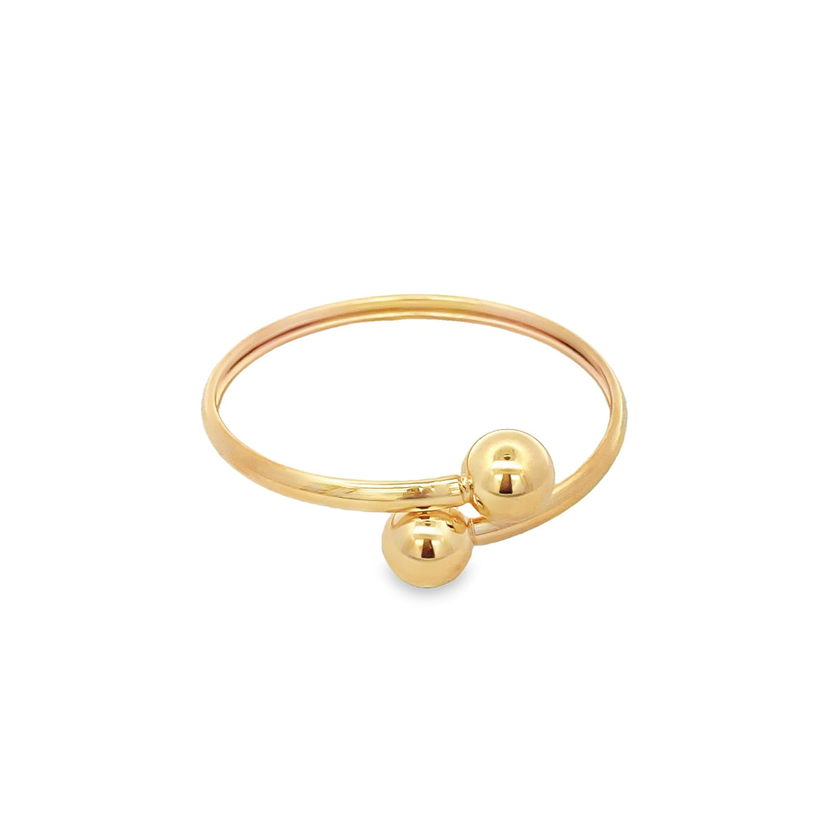 A delicate gold bypass ring features two polished spherical ball accents on a clean white background.