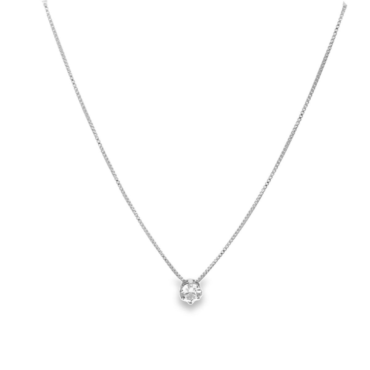 A delicate silver box chain necklace features a sparkling solitaire diamond pendant resting centrally against a plain white background.
