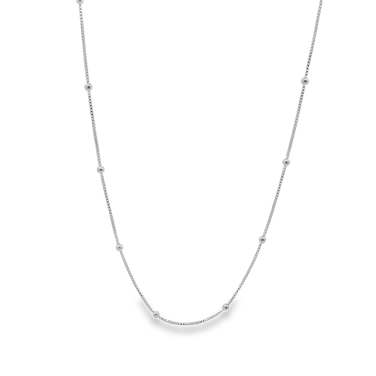 A delicate silver chain necklace features evenly spaced metallic bead accents against a clean white background.
