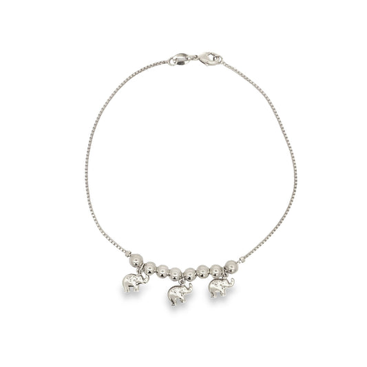 A delicate silver box chain bracelet features three charming elephant charms dangling gracefully among small metal beads.